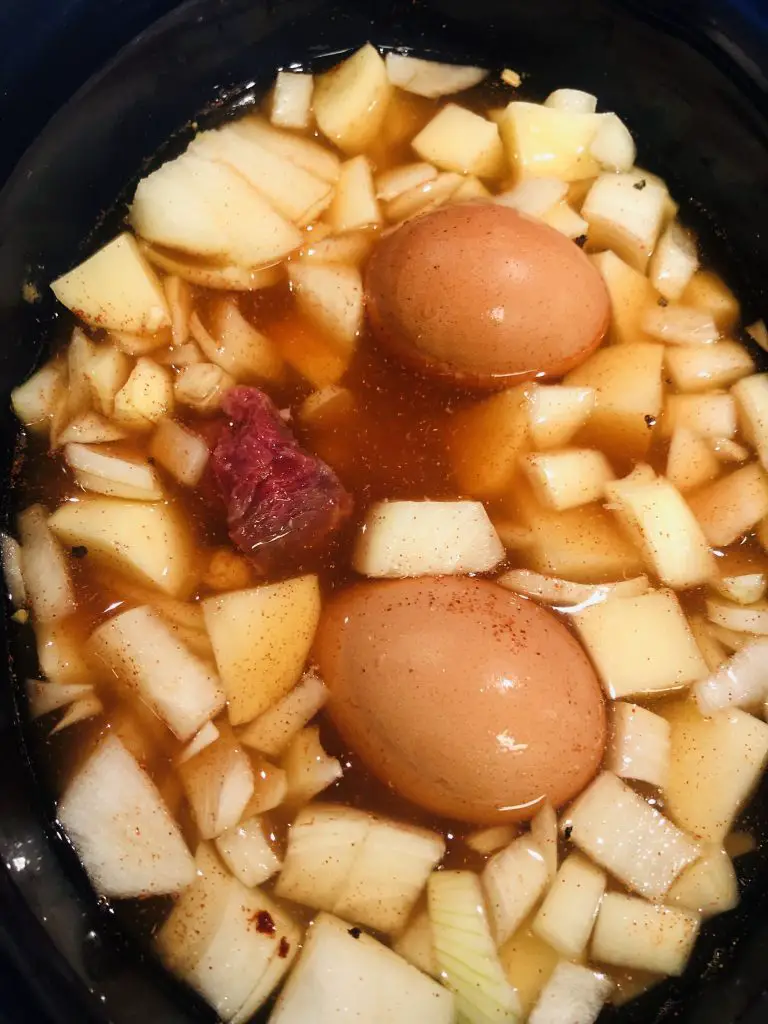eggs, diced potato and onion, beef, and water in a slow cooker