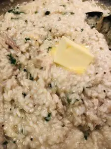 Chicken Risotto in a skillet with a knob of butter