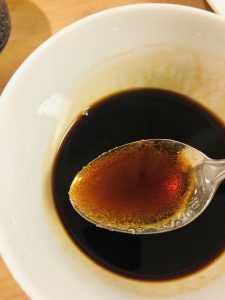 Sauce for Teriyaki Chicken in a white bowl with a spoon