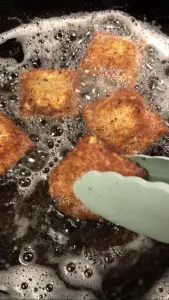 Toasted Ravioli frying in hot oil