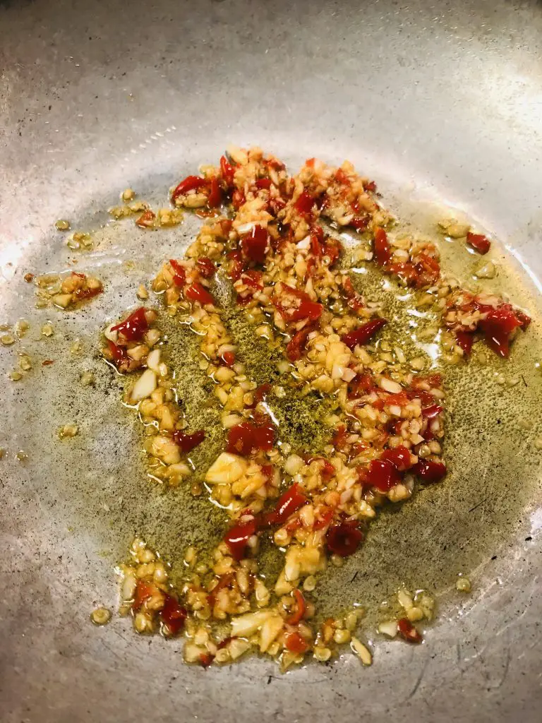minced garlic and chilies in olive oil in a skillet 