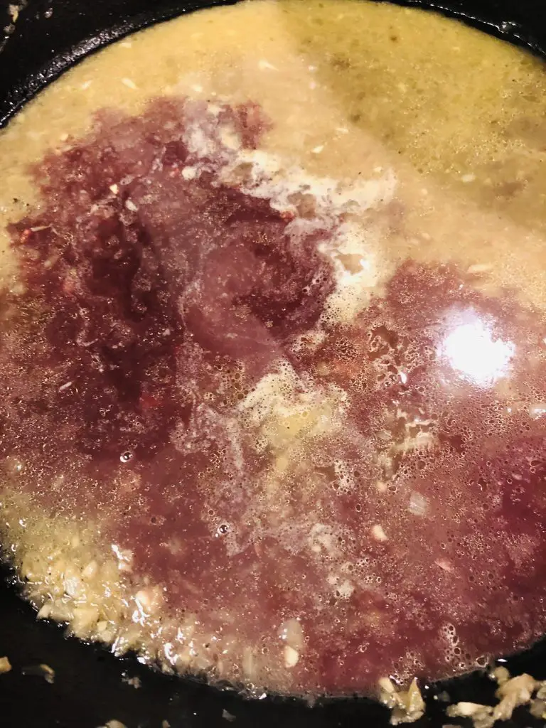Goose giblet broth with red wine in a pan