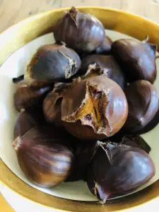 Roasted chestnuts in a gold rimmed bowl
