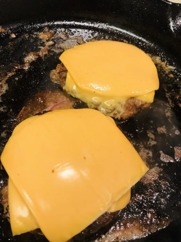 cheeseburgers in a cast iron skillet