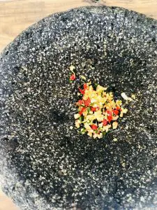 Minced chilies and garlic in a molcajete