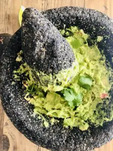 Guacamole in a molcajete with a pestle