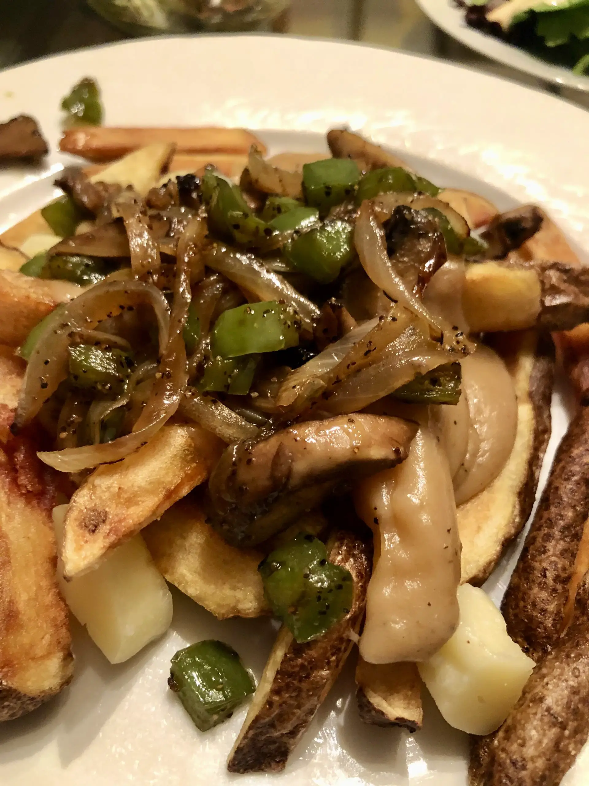 Poutine with mushrooms, onions, and green bell peppers