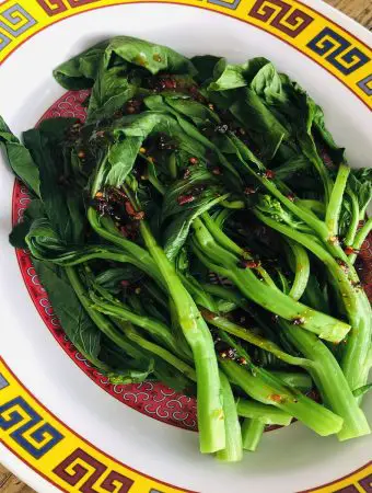 Yu Choy drizzled with a spicy sauce