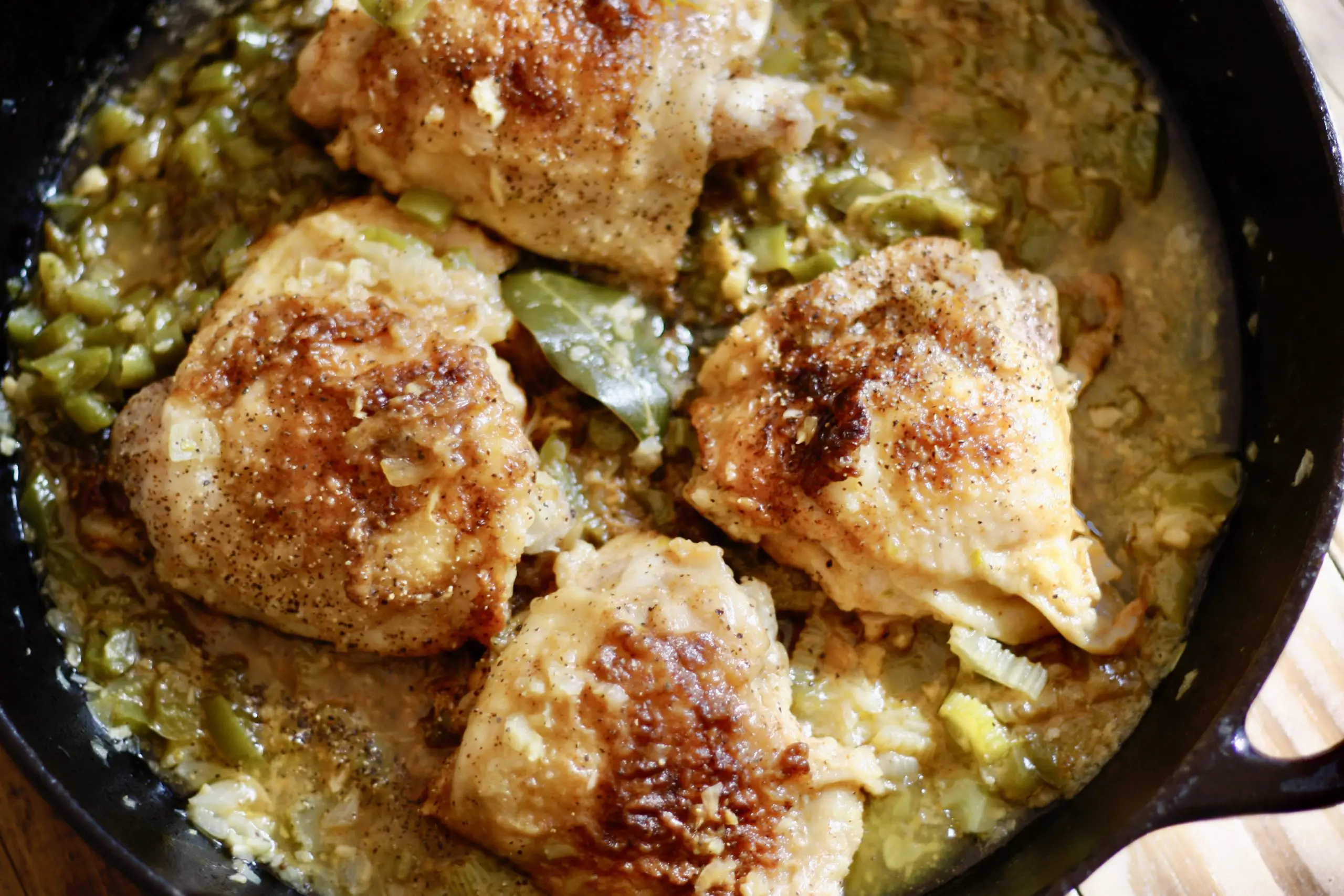 Cajun Smothered Chicken in a cast iron pan