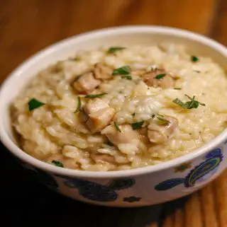 Chicken Risotto garnished with parsley in a bowl with paisley print