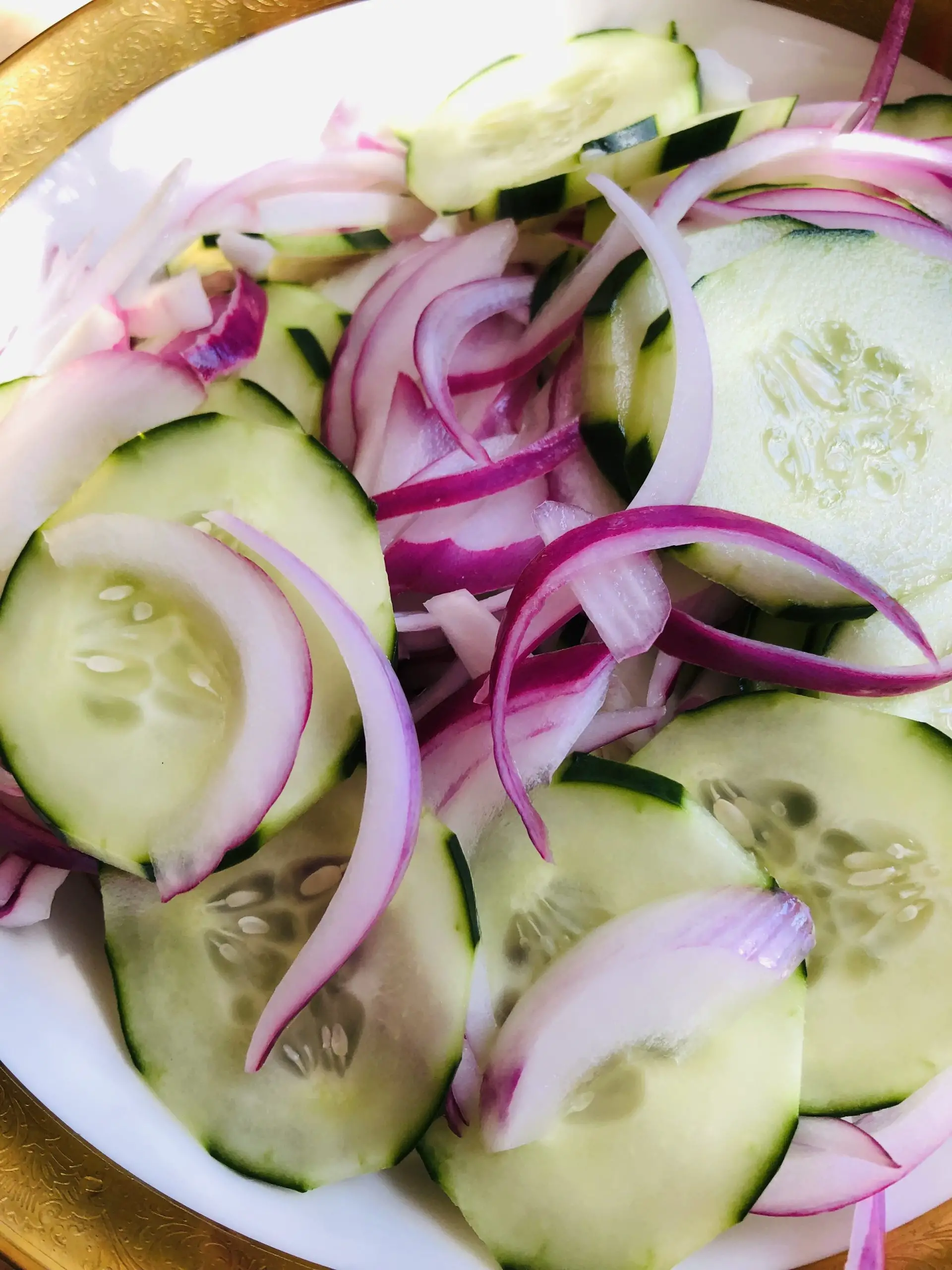 Southern Cucumber Salad in a gold rimmed bowl.