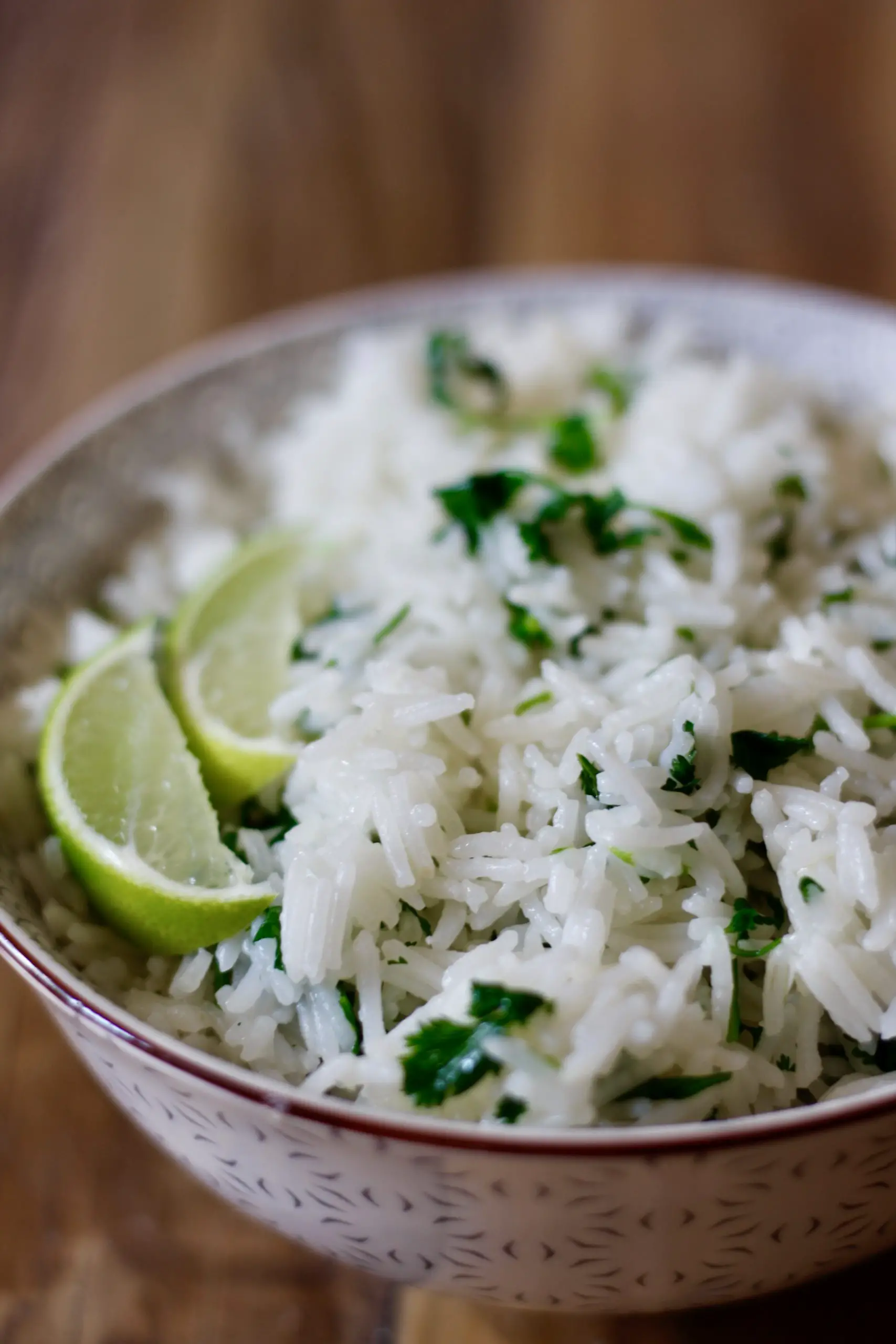 Cilantro Lime Rice in a bowl with slices of lime