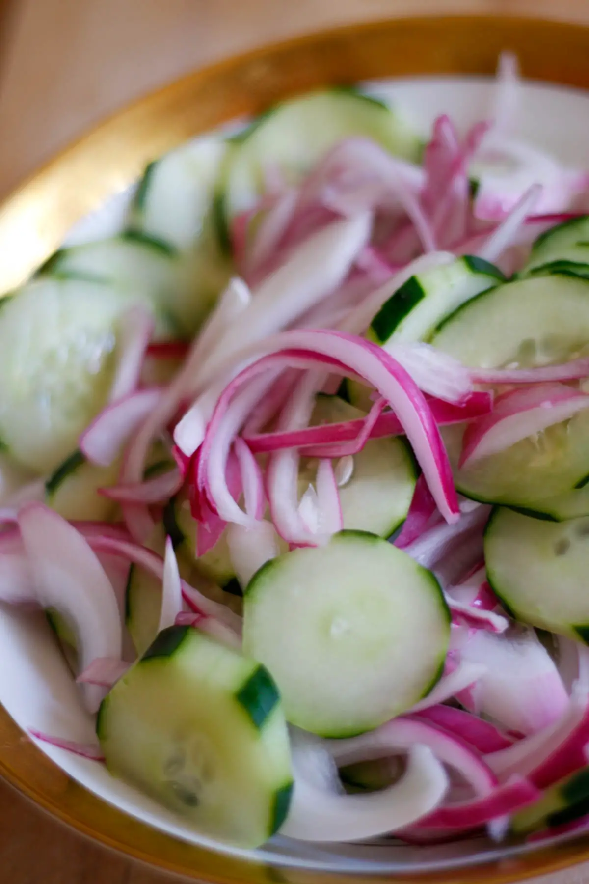 Southern Cucumber Salad in a gold rimmed bowl