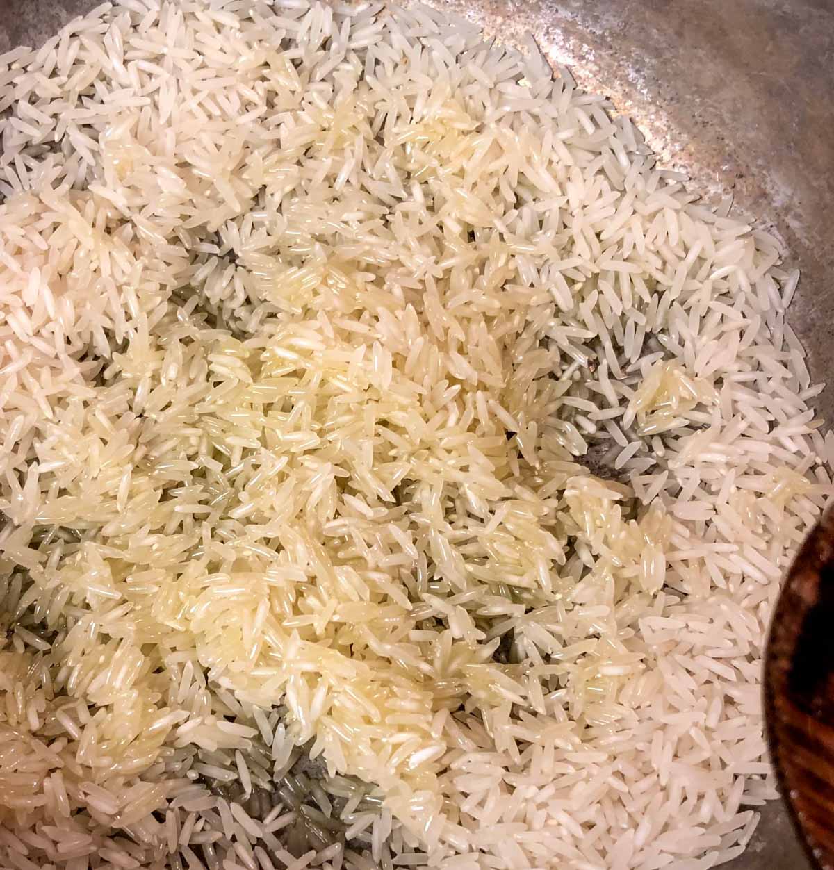 Grains of basmati rice in a pot that have been coated in oil
