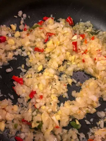 Minced onion, garlic, ginger, and chilies in a pot