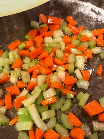 Diced carrots and celery in butter in a skillet.