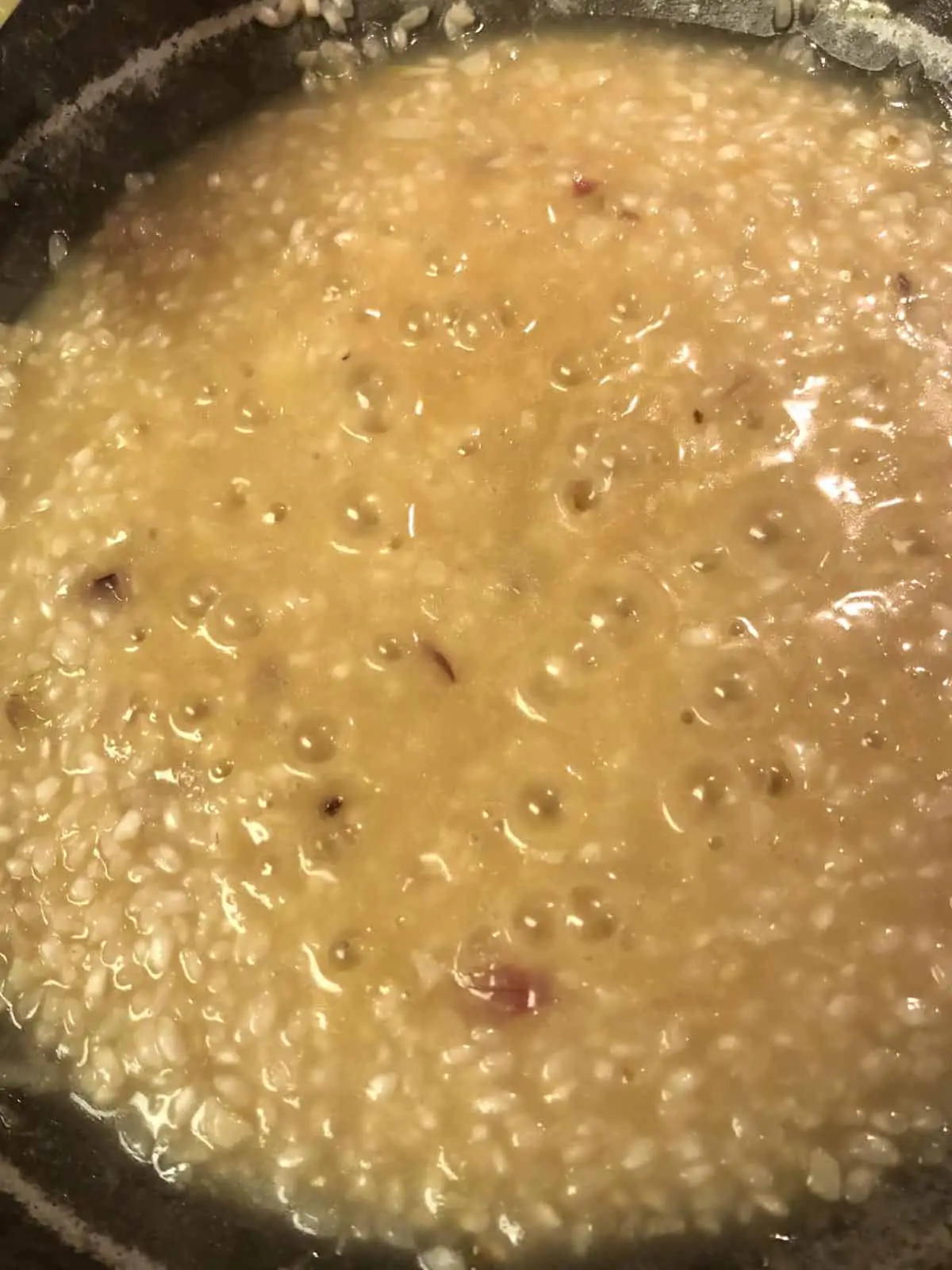 Creamy risotto rice in a skillet.