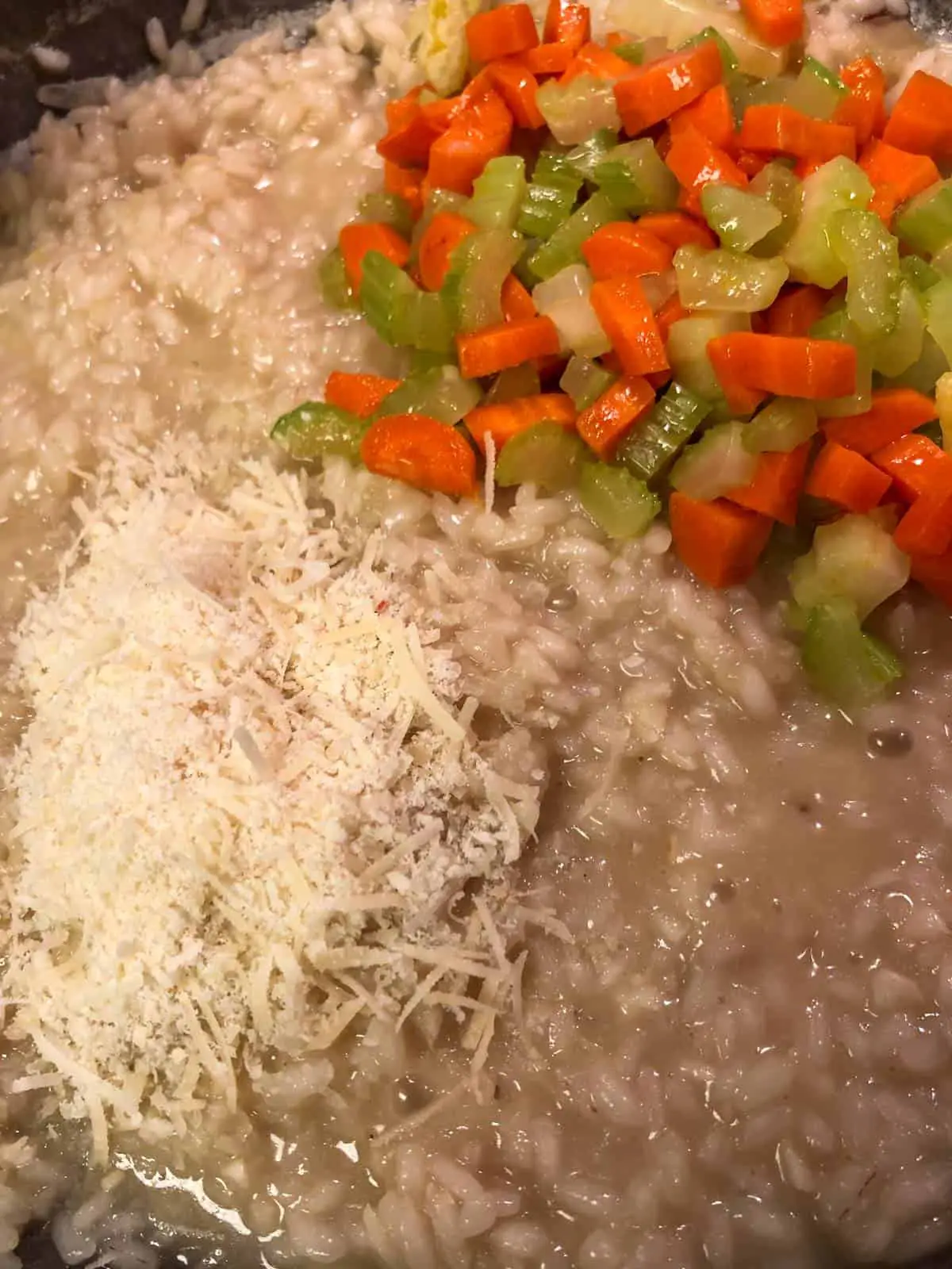 Creamy risotto rice with grated Parmigiano Reggiano and cooked diced carrots and celery.