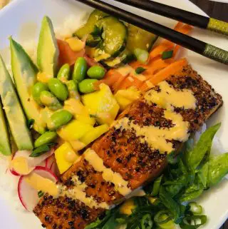 Salmon Rice Bowl with vegetables in a white bowl with chopsticks