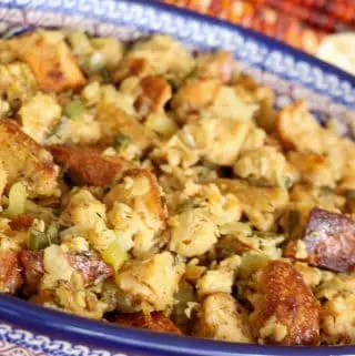 age and onion stuffing in a blue Polish pottery dish with colorful corn cobs in the background.