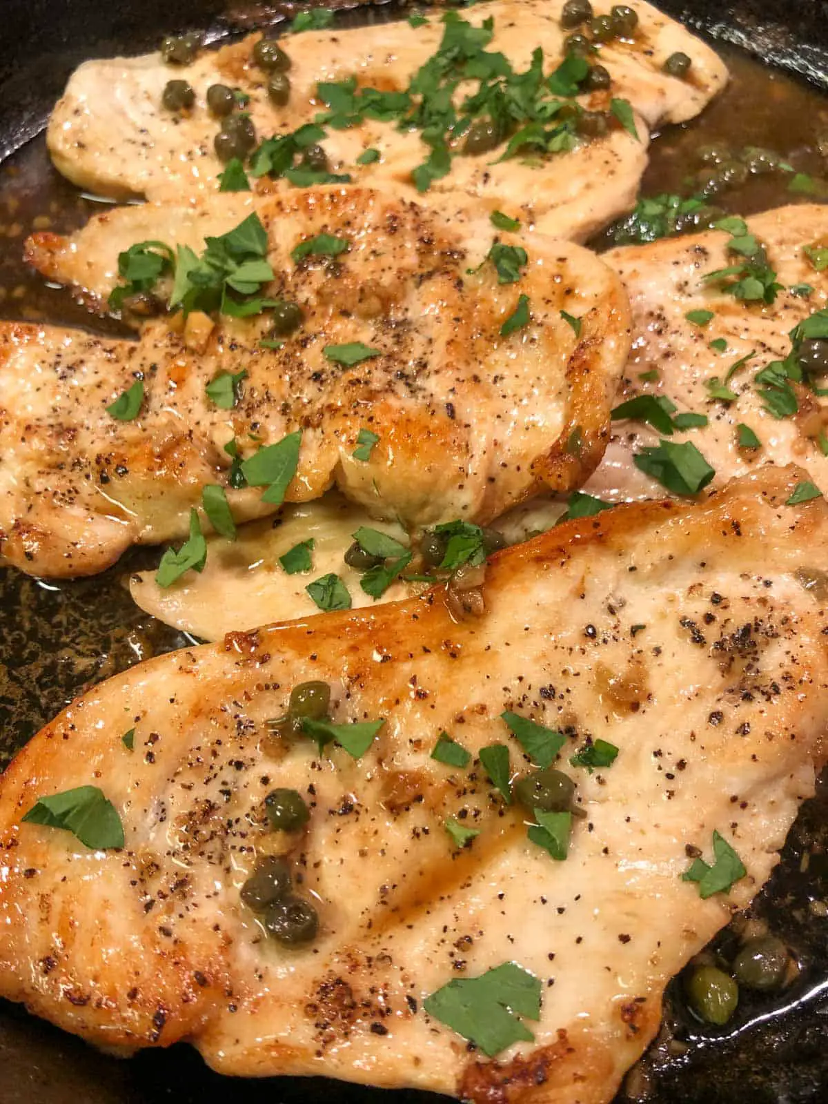 Seasoned thinly sliced chicken breast cooked in a lemon and caper sauce garnished with Italian parsley.