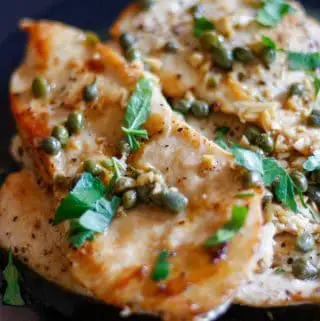 Chicken scallopini or thin slices of chicken cooked and garnished with Italian parsley with a sauce of capers, garlic, lemon juice, chicken broth and butter poured over the chicken.