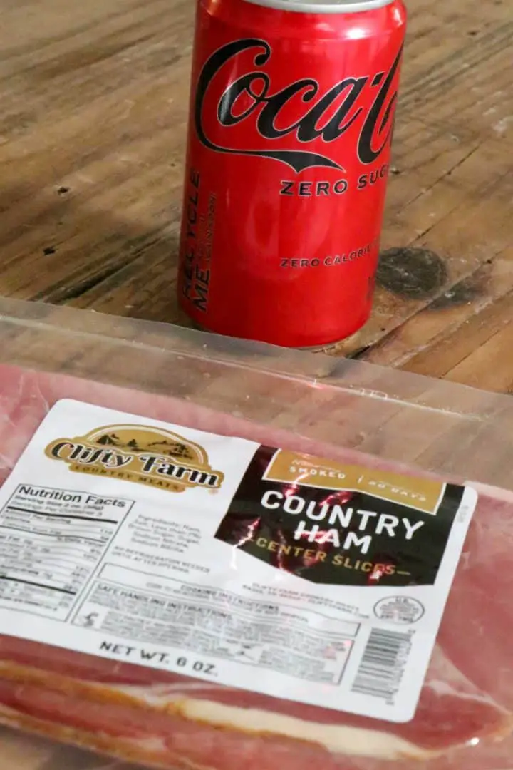 Package of country ham and a can of coke zero in the background.