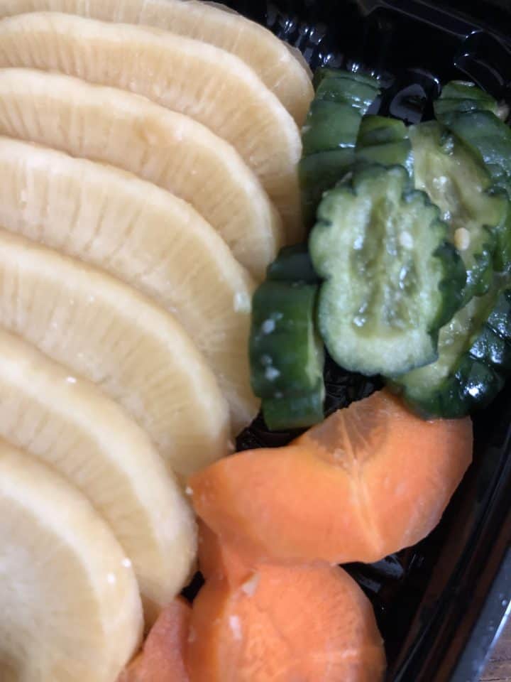 Pickled vegetables including daikon radish, cucumber, and carrots.