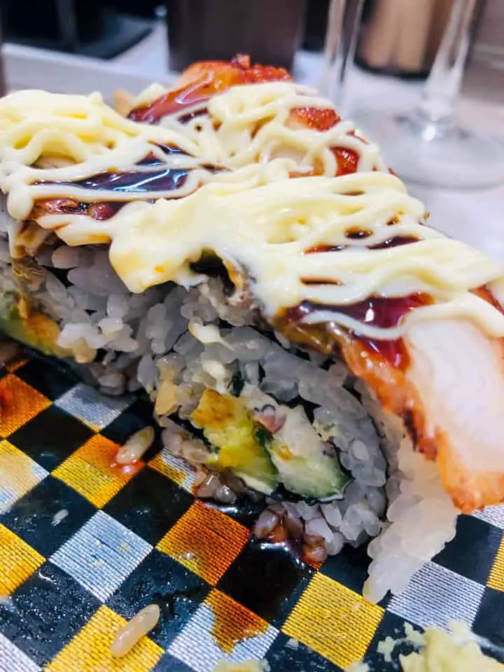 Sushi pieces topped with mayonnaise.