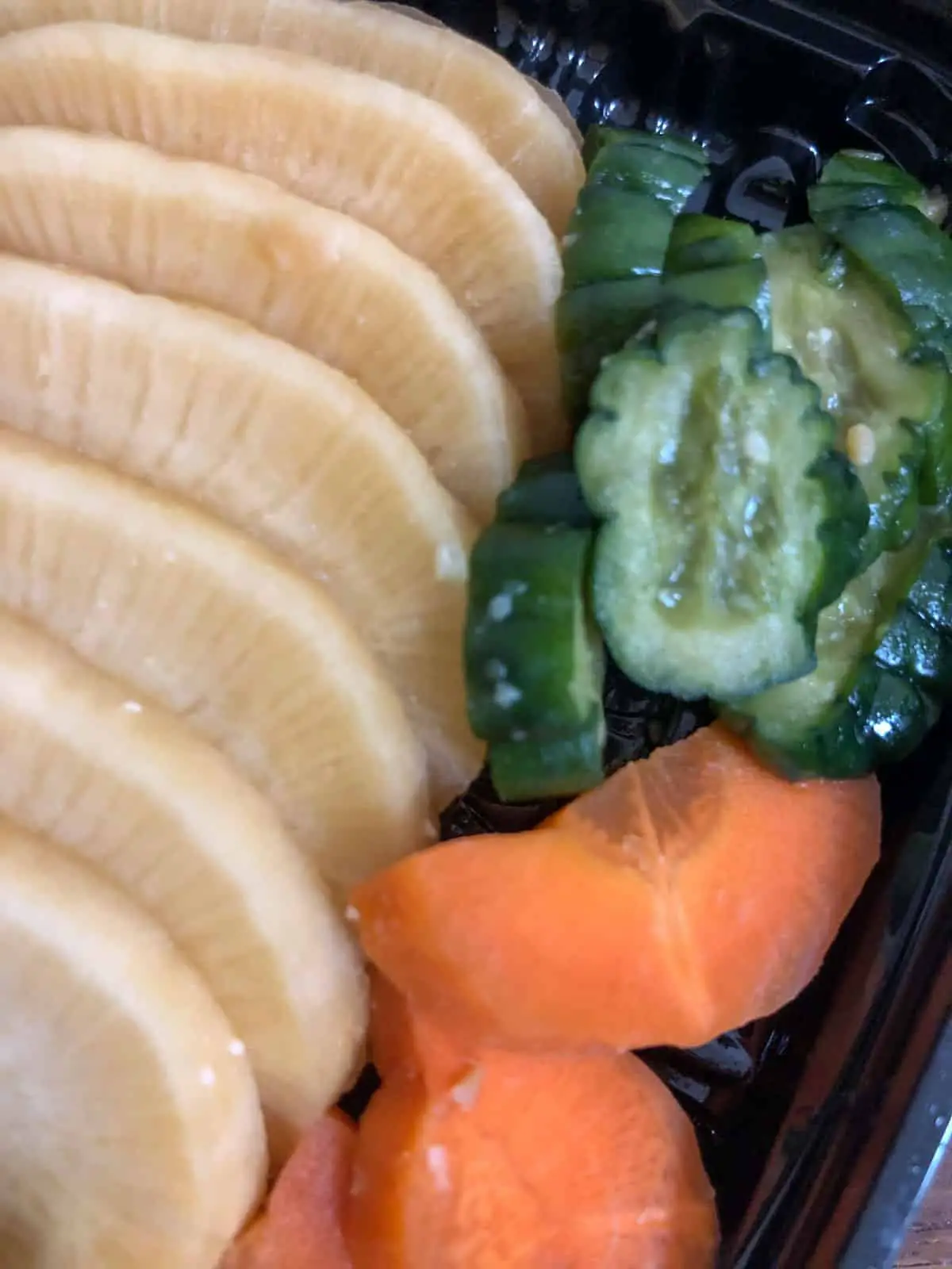 An assortment of Japanese pickles including daikon, cucumbers, and carrots. 