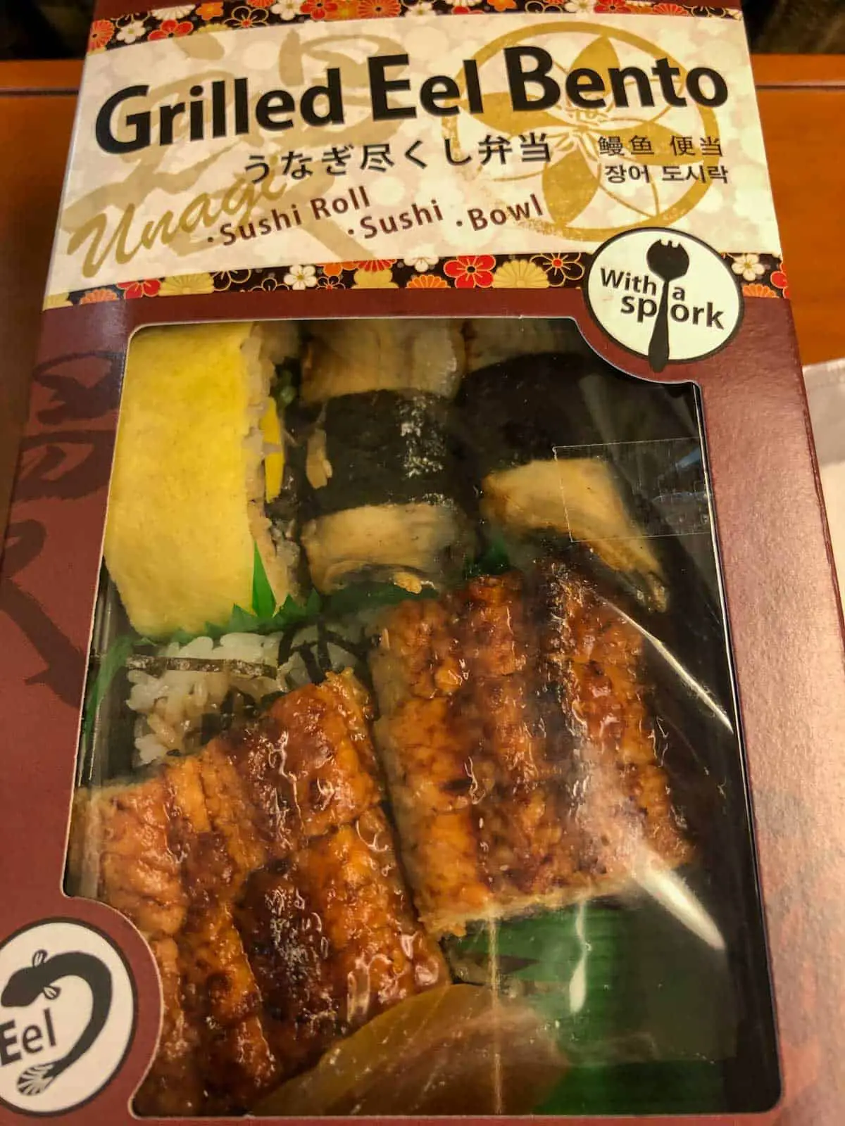 Grilled eel bento box including sushi and rice, and Japanese omelette. 