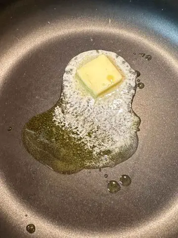 Melting butter and olive oil in a large pot.