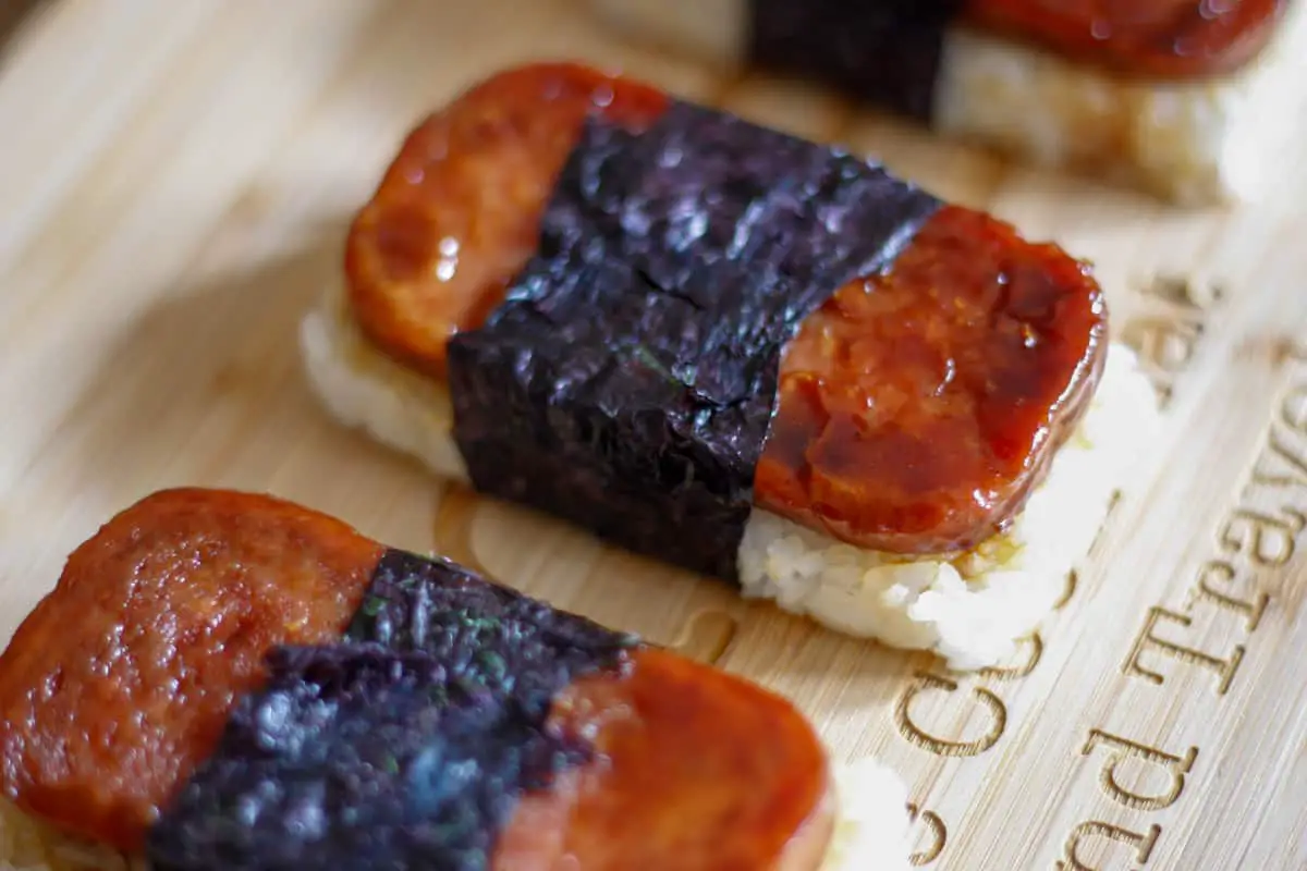 Several Spam Musubi's which are Spam slices on top of a bed of rice wrapped in nori.