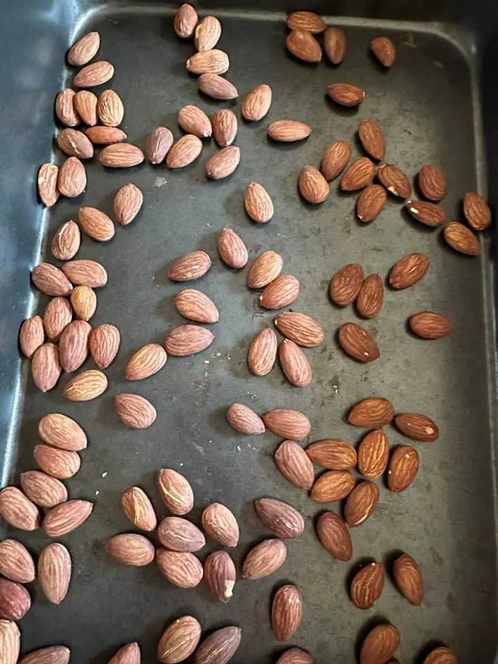 Roasted almonds in a roasting tin.
