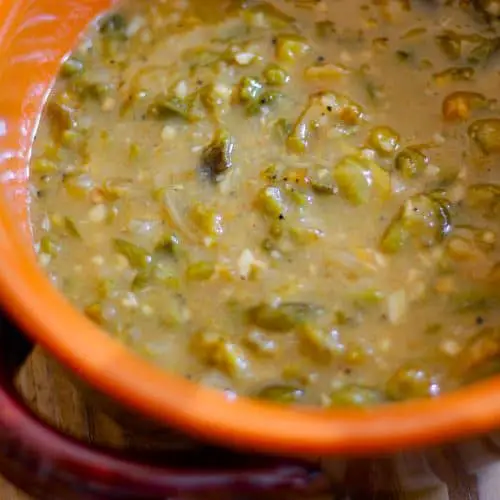 Green chile sauce in a terracotta bowl.