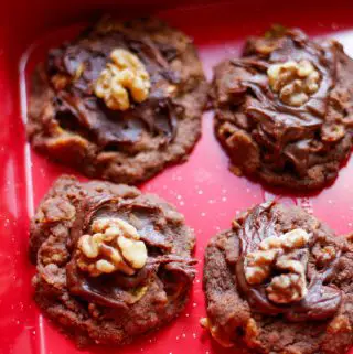 New Zealand Afghan Cornflake cookies displayed on a red baking tray.