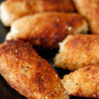 Several golden brown ground chicken cutlets displayed on a plate.