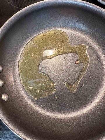 Oil from a can of tuna in a skillet.