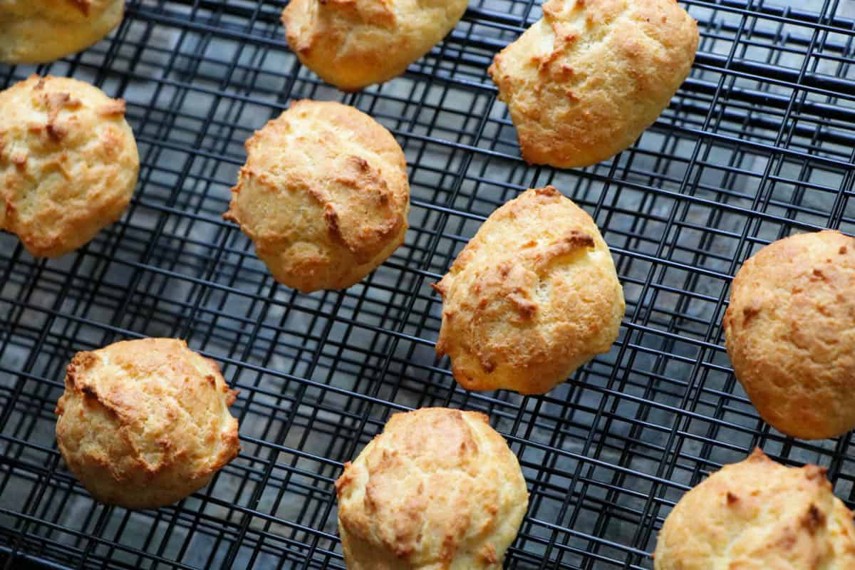 Parmesan cheese drop biscuits on a cooling rack.