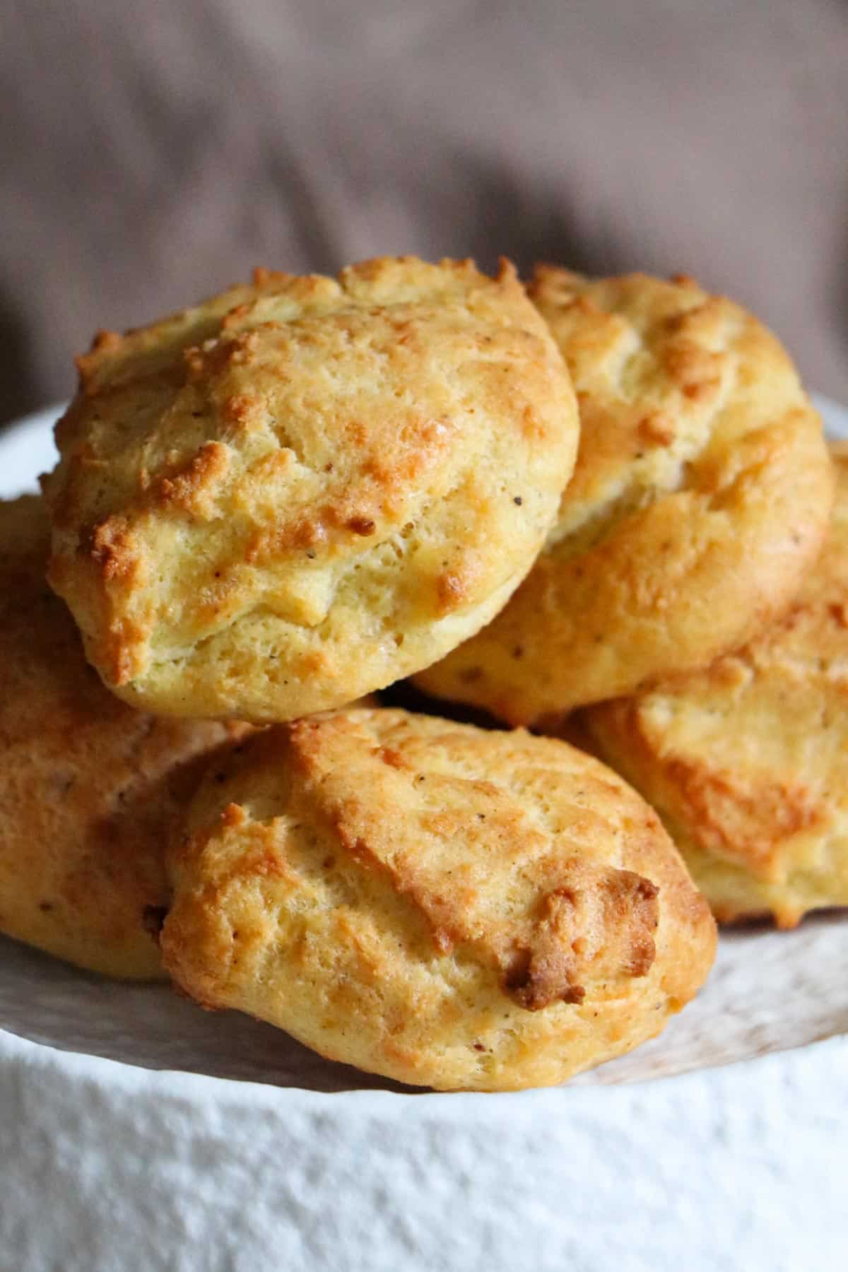 Gruyere drop biscuits on a serving plate.