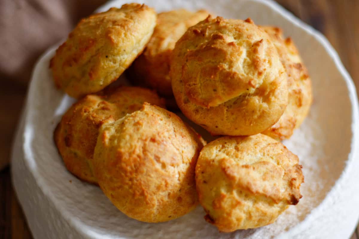 Gruyere drop biscuits on a serving plate.